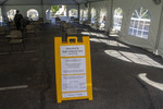Ruth Williams Tent Desks with Regulations Sign by Tobin Chin
